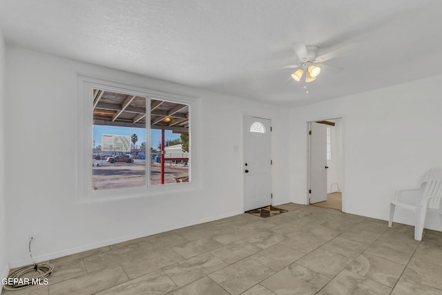 entrance foyer featuring a textured ceiling and ceiling fan