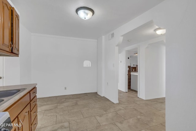 kitchen with light tile patterned floors and sink