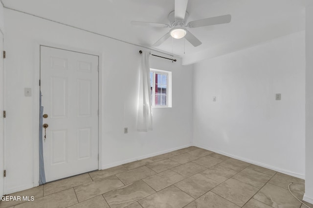 tiled empty room with ceiling fan