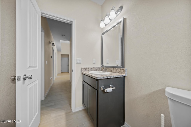 bathroom featuring vanity and toilet