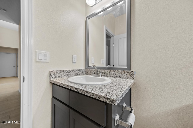 bathroom with hardwood / wood-style floors and vanity