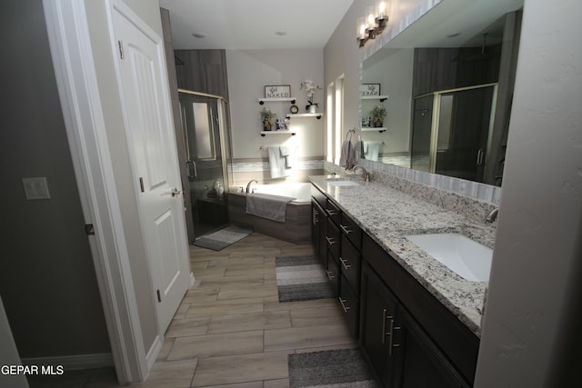 bathroom with independent shower and bath and vanity