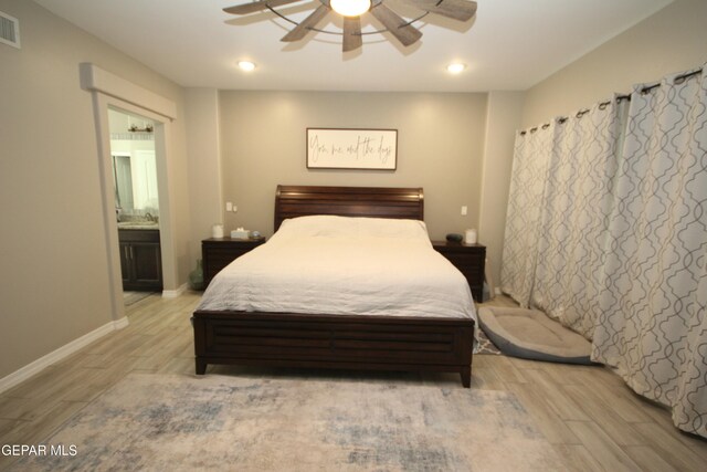 bedroom featuring ensuite bath, ceiling fan, and light hardwood / wood-style floors