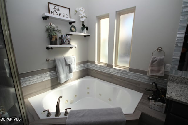 bathroom with vanity and a bath