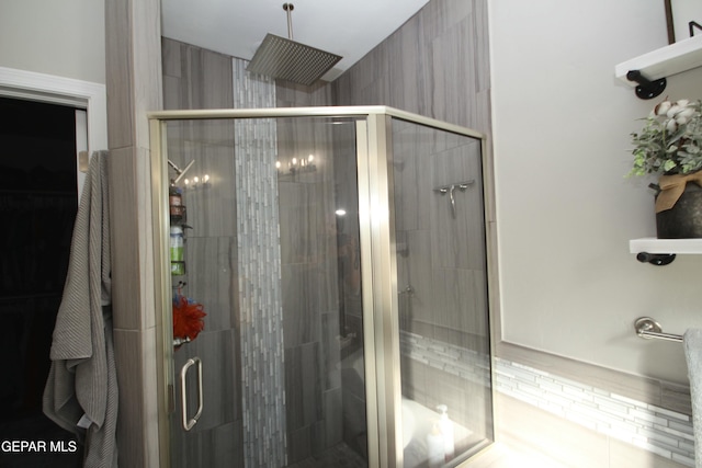 bathroom with a shower with door