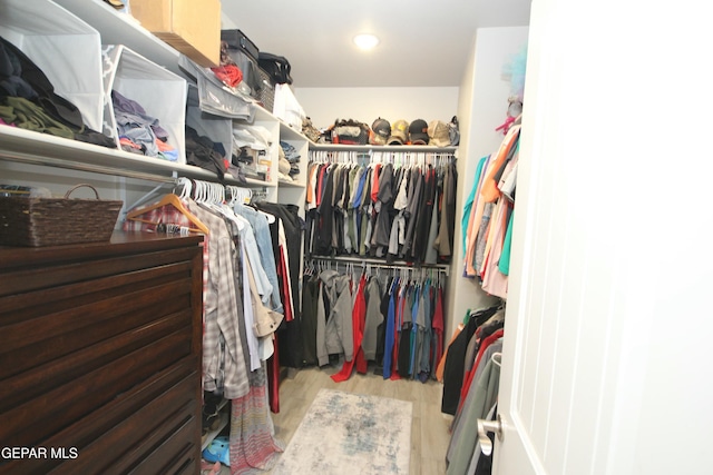 walk in closet with hardwood / wood-style floors