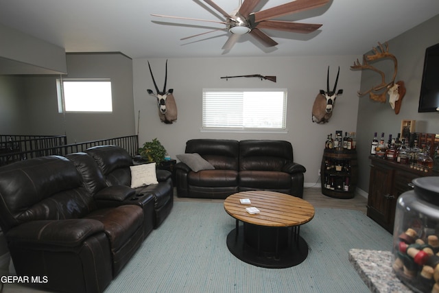 living room featuring ceiling fan, light hardwood / wood-style floors, and plenty of natural light