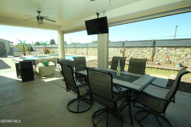 view of patio / terrace featuring ceiling fan and a fenced in pool