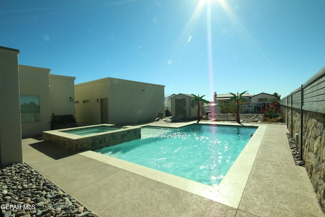 view of swimming pool with a patio and an in ground hot tub