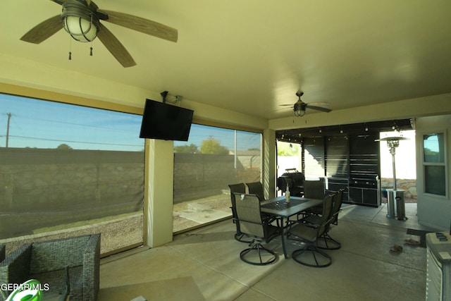 sunroom / solarium featuring ceiling fan