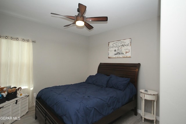 bedroom with ceiling fan and light wood-type flooring