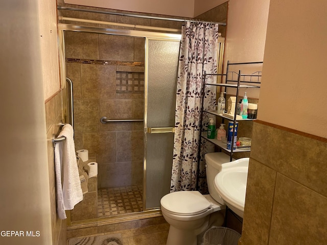 bathroom featuring toilet, tile patterned floors, and walk in shower