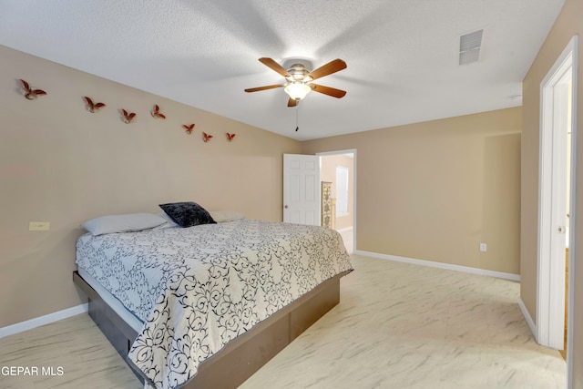 carpeted bedroom featuring ceiling fan and a textured ceiling