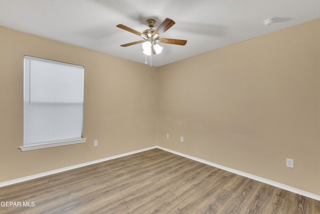 spare room featuring a textured ceiling, hardwood / wood-style flooring, and ceiling fan