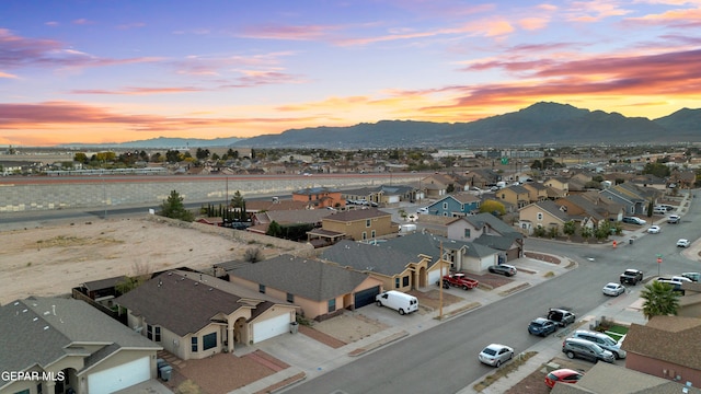 aerial view at dusk featuring a mountain view