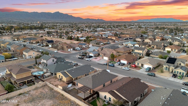 aerial view at dusk featuring a mountain view