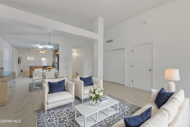 living room featuring ceiling fan, light hardwood / wood-style floors, and high vaulted ceiling