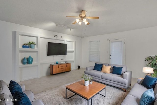 carpeted living room featuring ceiling fan