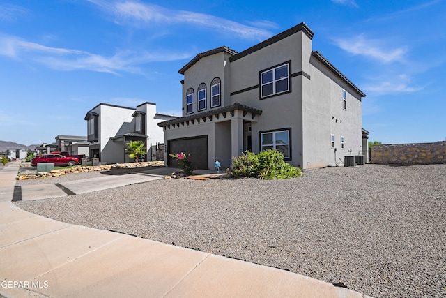 view of front of house featuring central AC unit and a garage