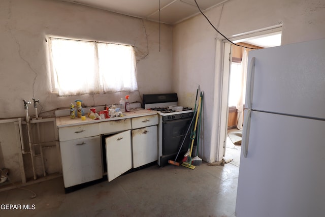 kitchen featuring white cabinetry and white appliances