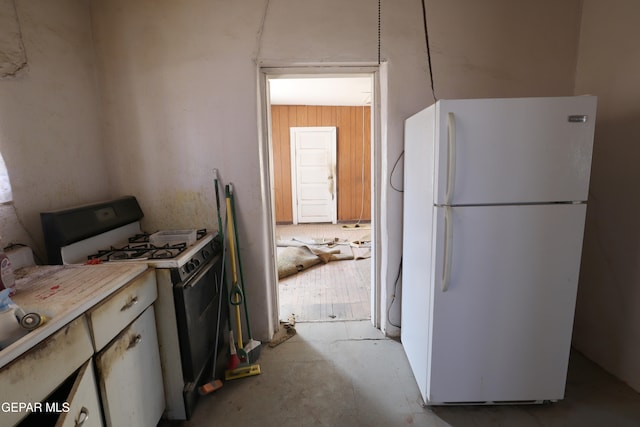 kitchen featuring white appliances and white cabinetry