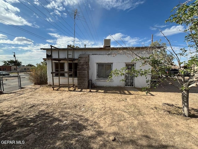 rear view of property with cooling unit