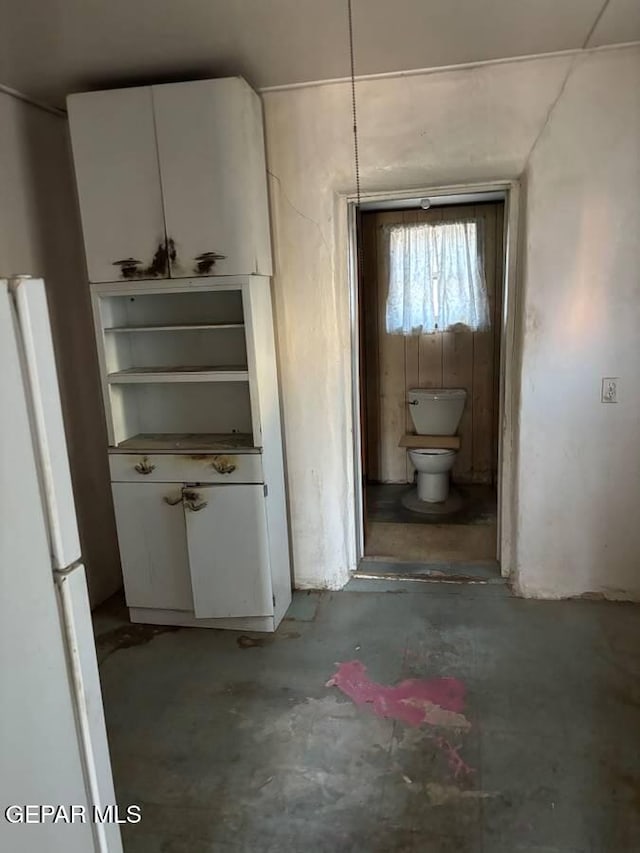 hallway with concrete flooring