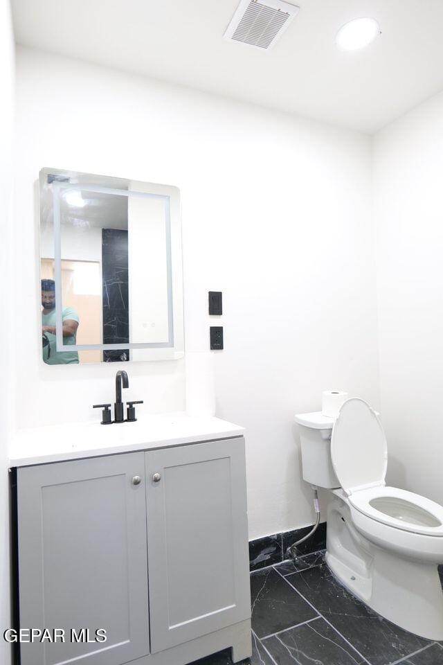 bathroom with vanity and toilet