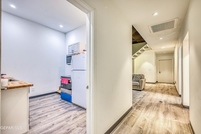 hallway with light wood-type flooring