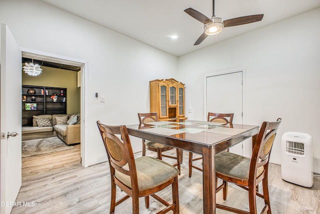 dining area featuring ceiling fan and light wood-type flooring