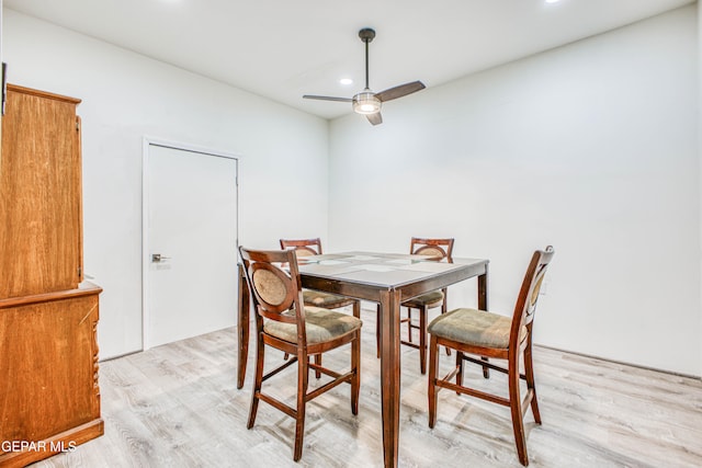 dining space featuring ceiling fan and light wood-type flooring