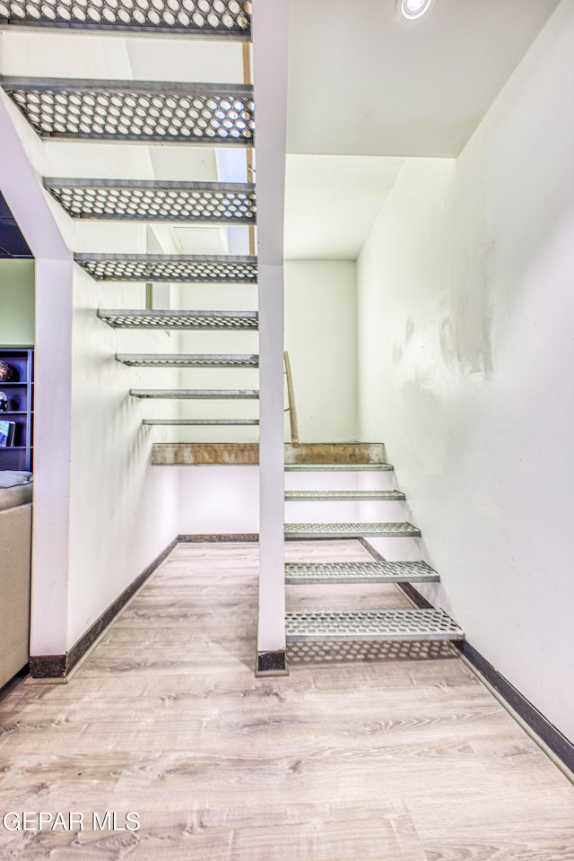 staircase with wood-type flooring