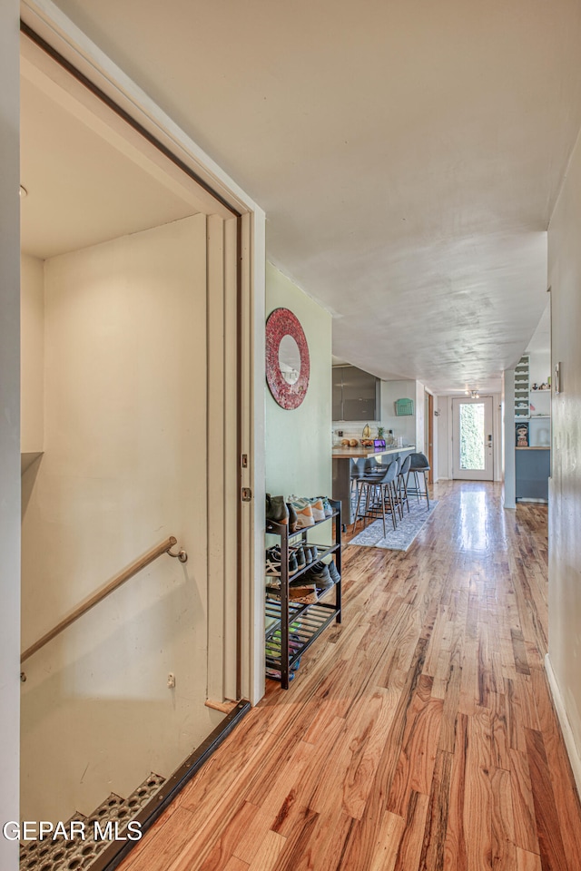 hall with hardwood / wood-style floors