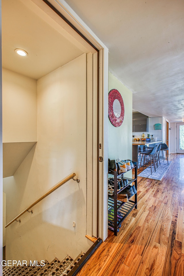 hall with hardwood / wood-style flooring