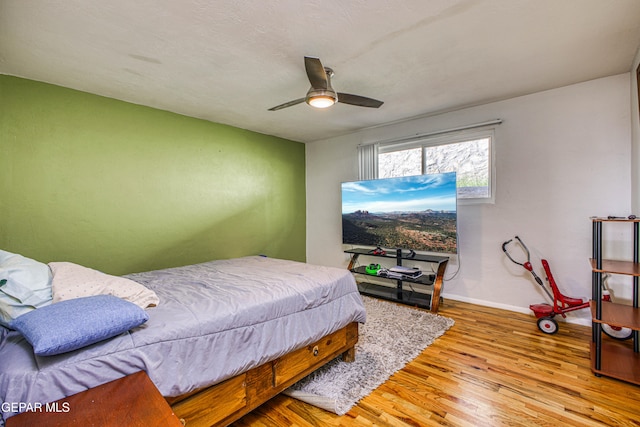 bedroom featuring ceiling fan and light hardwood / wood-style floors