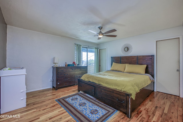 bedroom with ceiling fan and light hardwood / wood-style flooring