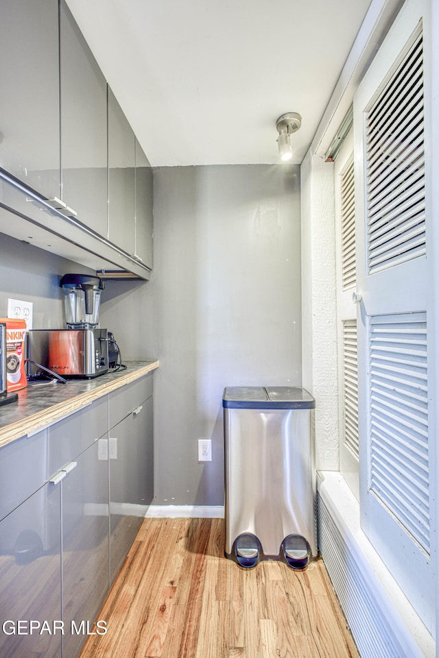 kitchen featuring gray cabinets and light wood-type flooring