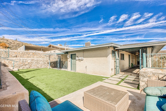 back of house featuring a yard and a patio area