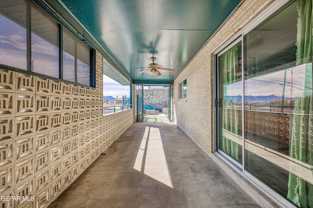 view of patio featuring ceiling fan and a balcony