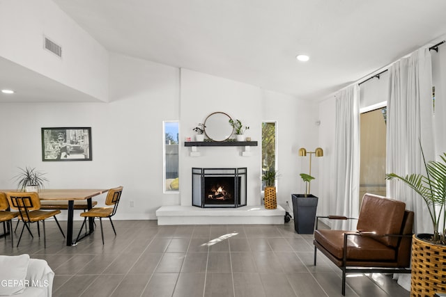 tiled living room featuring high vaulted ceiling