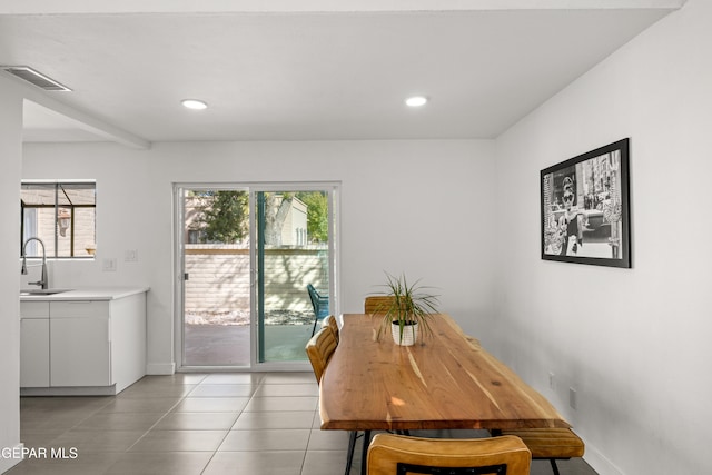 dining room with light tile patterned floors, a wealth of natural light, and sink