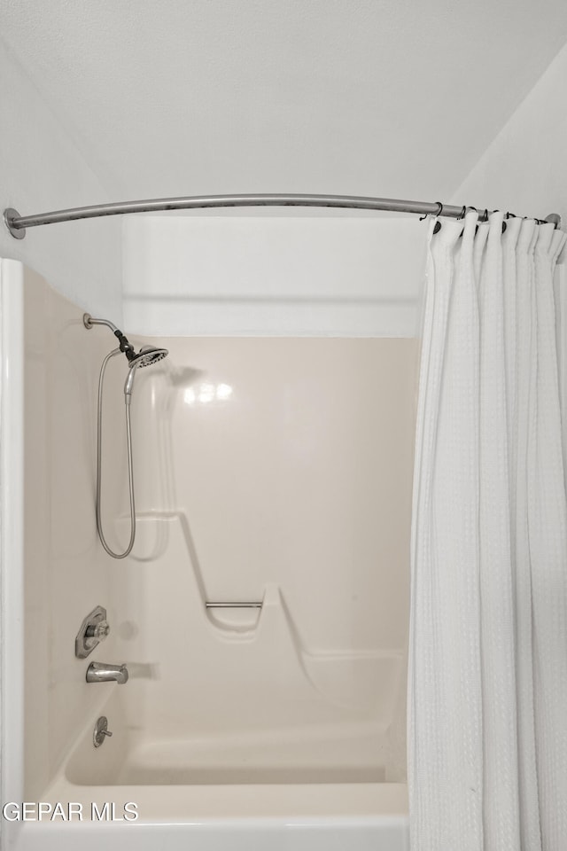 bathroom with shower / bath combo