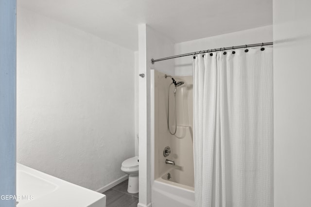 bathroom with tile patterned floors, shower / bath combination with curtain, and toilet