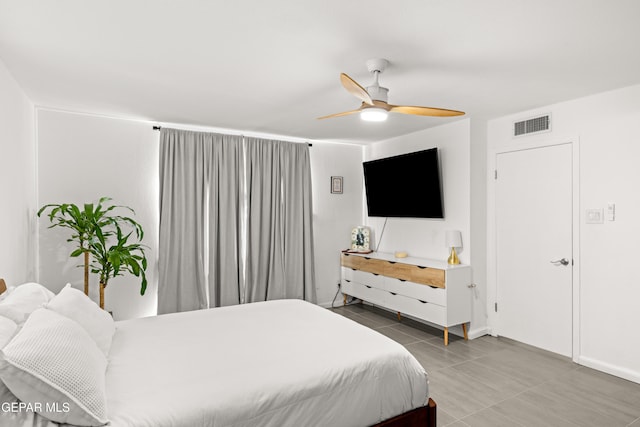 bedroom with tile patterned floors and ceiling fan