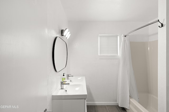 bathroom with shower / tub combo and vanity