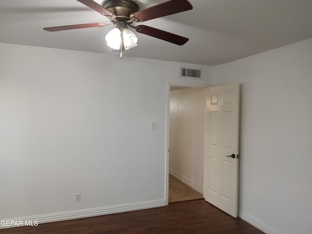 spare room featuring dark hardwood / wood-style floors and ceiling fan