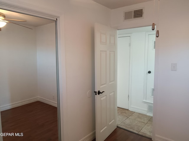 corridor with hardwood / wood-style floors