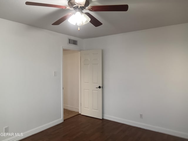 unfurnished room with ceiling fan and dark wood-type flooring