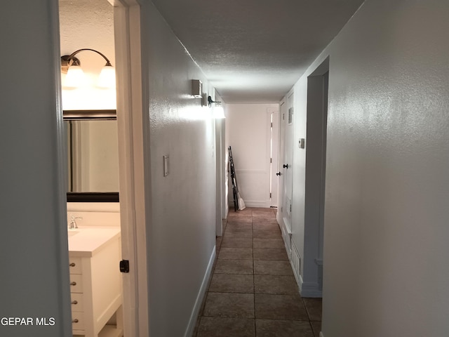 hallway featuring dark tile patterned flooring