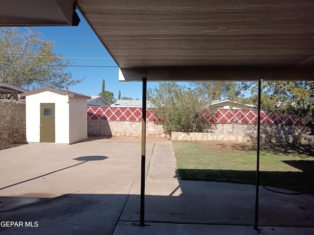 view of patio / terrace featuring a storage unit